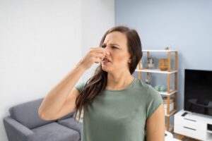 Woman Noticing Heat Pump Odors and Noises