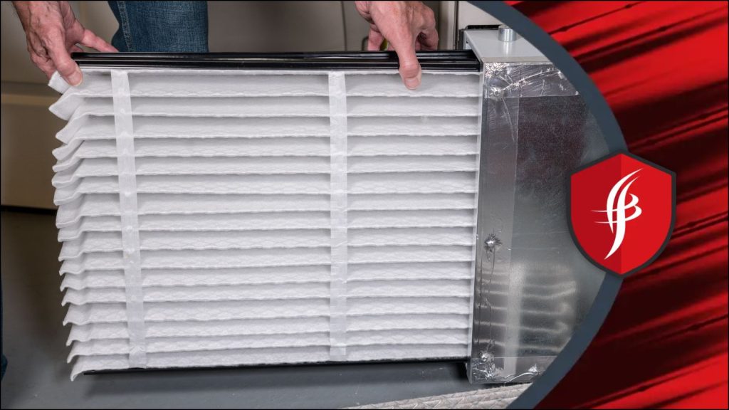 An HVAC tech replacing an air filter.