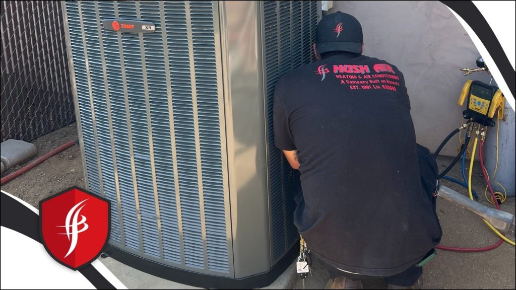 A Hush Air HVAC tech servicing an AC unit.